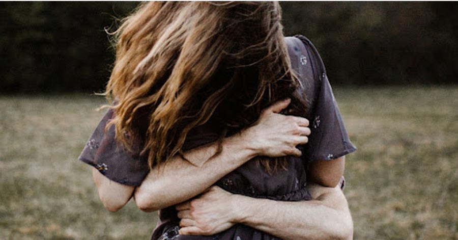 A photo of a woman embraced.